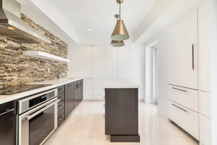 Sleek custom Kitchen with a service entrance door