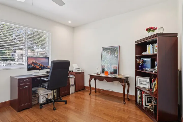 Wood-finish flooring, large window with horizontal blinds, and recessed ceiling lighting
