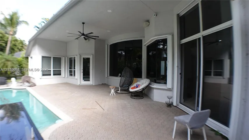Covered patio featuring a paver deck, recessed lighting, ceiling fan, and access to an in-ground pool