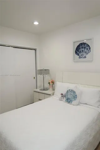 Room featuring a neutral color palette, recessed lighting, and a sliding panel closet door