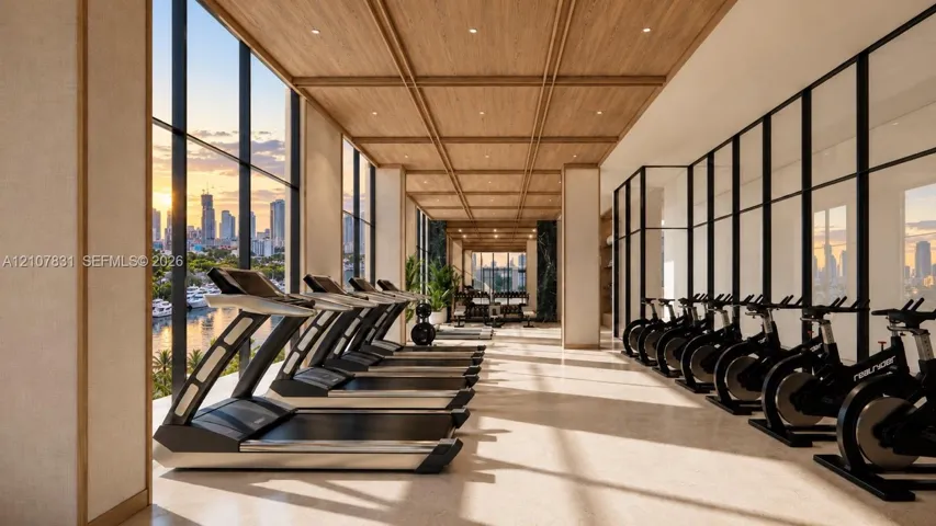 Fitness center featuring floor-to-ceiling windows, wood-paneled coffered ceilings, recessed lighting, and stone-finish flooring