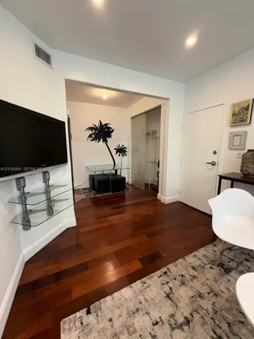 Wood-finish flooring, recessed lighting, and frosted glass sliding doors