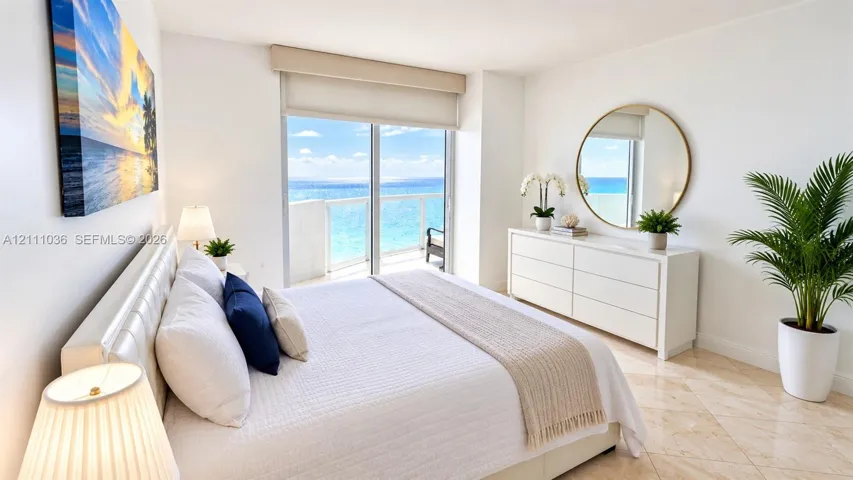 Polished stone flooring, floor-to-ceiling sliding glass doors, and a private balcony overlooking the ocean