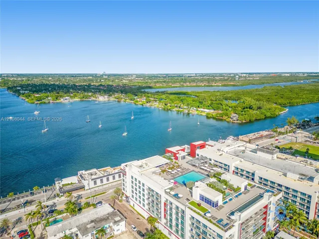 Waterfront property featuring a rooftop pool, multiple terraces, and expansive aquatic scenery
