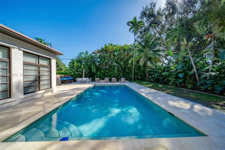 Pool perfectly placed n the private, lushly landscaped lot