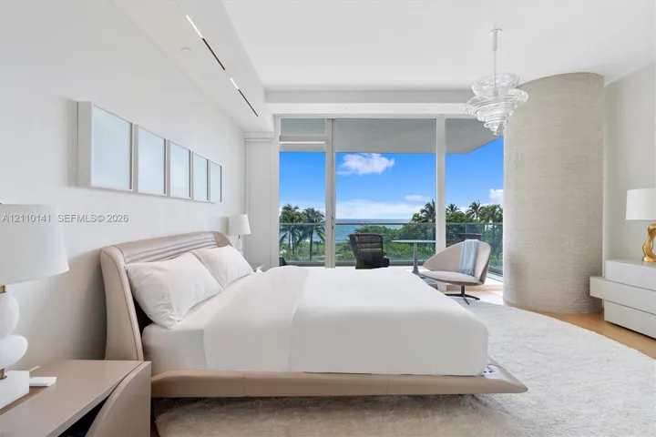 Master bedroom ,Floor-to-ceiling glass doors, private balcony, wood-finish flooring , Exquisite contemporary furnishings