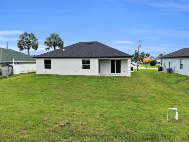 Rear exterior with lanai and sliding glass doors.