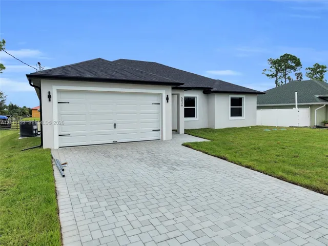 Angled view of the 2-car garage and paved driveway.