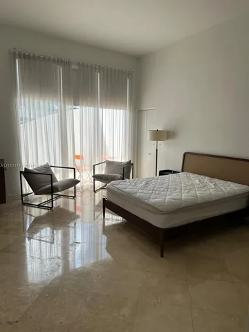 Polished stone flooring, expansive floor-to-ceiling windows, and recessed ceiling lighting