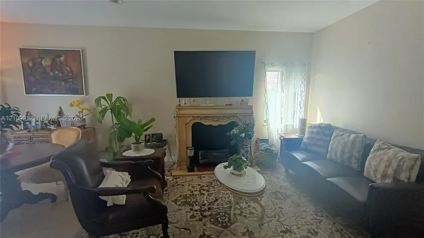 Ornate fireplace mantle with decorative carved detailing and recessed firebox