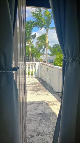 Exterior terrace featuring stone tile flooring and decorative balustrade railing