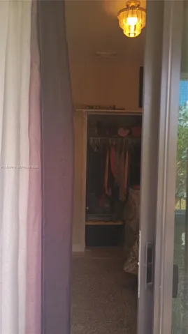 Flush-mount tiered glass ceiling fixture and built-in closet with integrated hanging rod and shelf