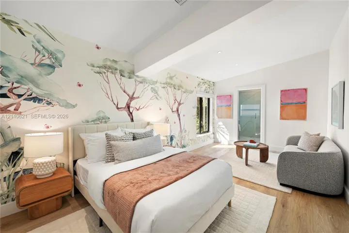 Vaulted ceilings, large-scale mural wall covering, wood-finish flooring, and glass-paneled interior door