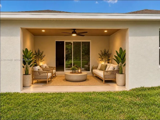 Covered rear patio featuring a wood-tone paneled ceiling, recessed lighting, ceiling fan, and sliding glass door