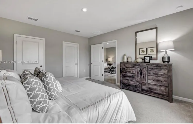 Neutral-toned interior featuring recessed lighting, carpeted flooring, and multi-panel interior doors