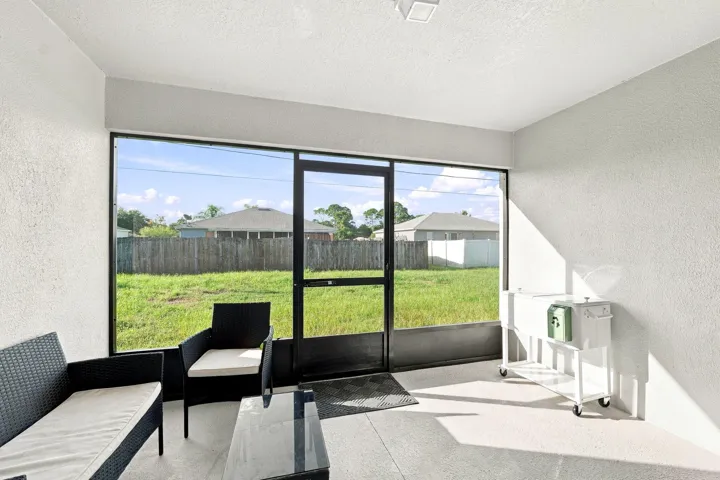 Screened lanai with sliding glass doors to the living room.