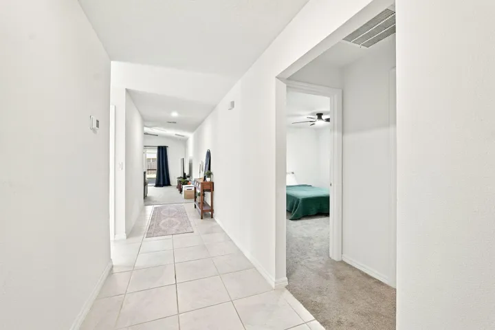 Tiled hallway connecting the bedrooms and living areas.