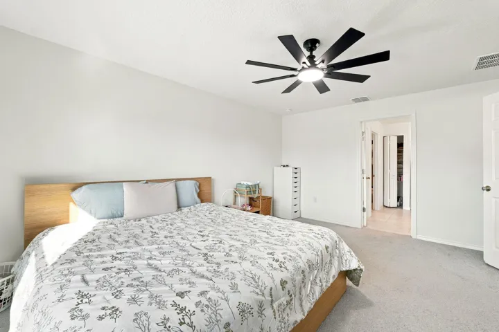 Primary bedroom with ceiling fan and private en-suite bath.