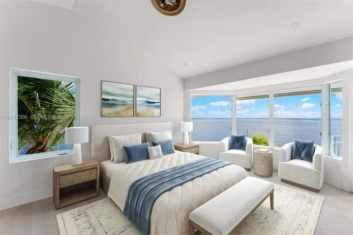Vaulted ceilings, expansive bay windows, and light-toned wood-finish flooring