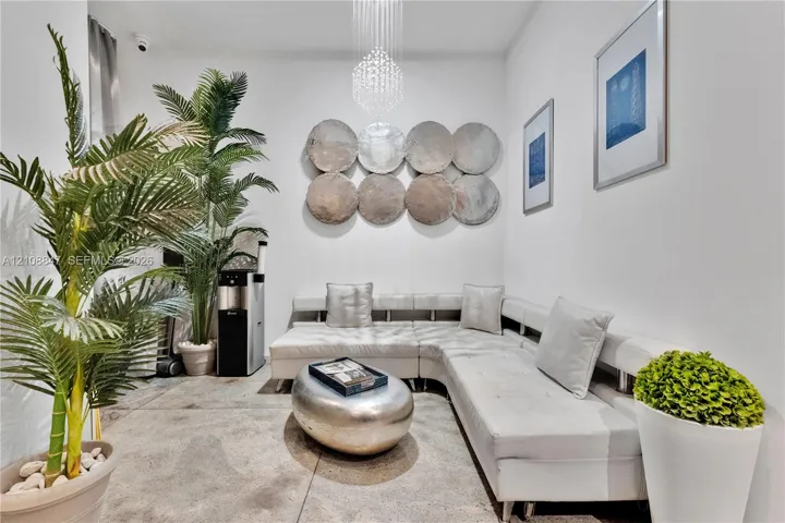 Polished concrete flooring paired with a tiered crystal chandelier and recessed ceiling lighting