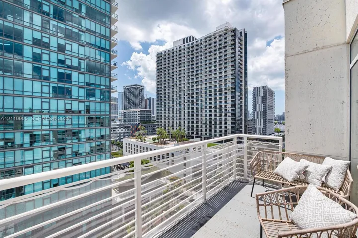 Private balcony featuring a white metal railing and concrete flooring