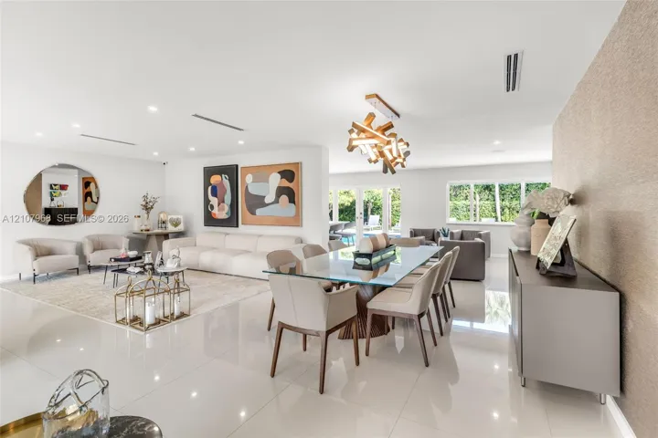 Large-format white tile flooring, modern geometric chandelier, textured feature wall, and multi-panel glass garden​​‌​​​​‌​​‌‌​‌‌​​​‌‌​‌​‌​‌​​​‌​​ doors