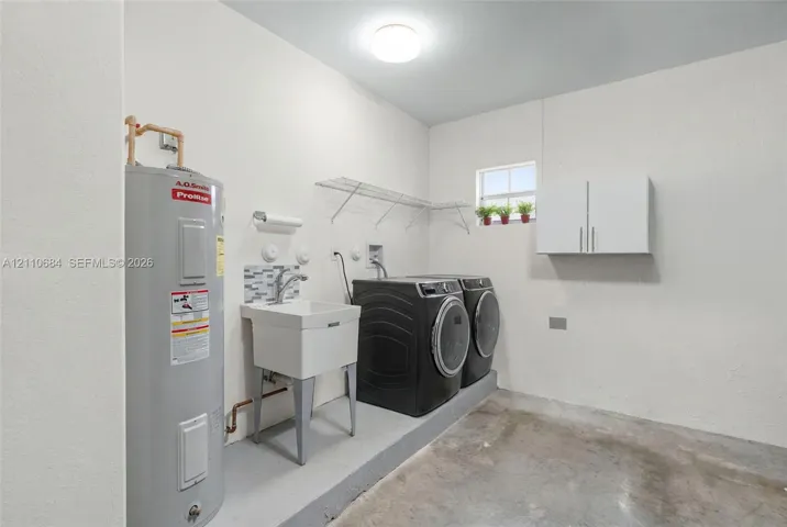 Laundry area with utility sink