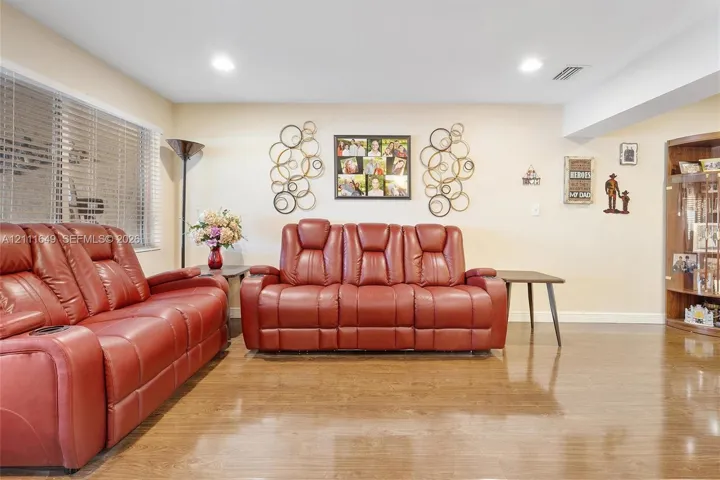 Wood-finish flooring, recessed lighting, and built-in wood cabinetry