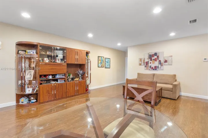 Open-concept space featuring wood-finish flooring and recessed lighting