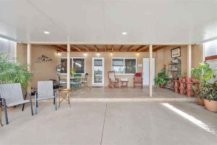 Covered patio featuring recessed lighting, a concrete floor, and tile surfacing