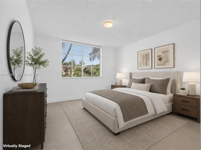 Neutral-toned large-format tile flooring, multi-pane window with exterior scenery, and central flush-mount ceiling lighting