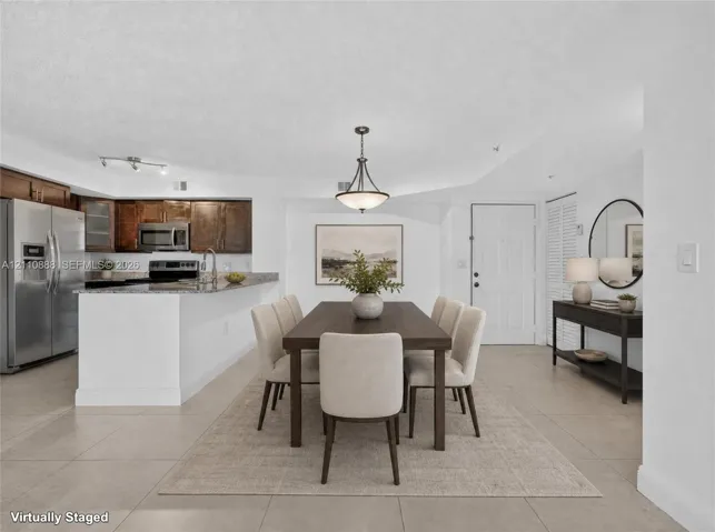 Kitchen featuring a peninsula, stainless steel appliances, and dark wood-finish cabinetry