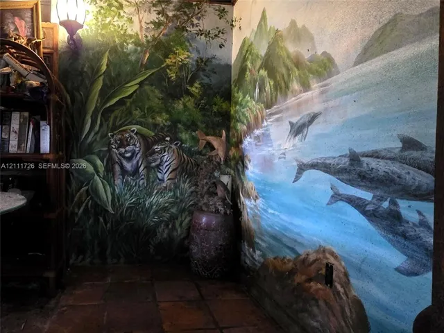 Custom wall murals featuring detailed nature and wildlife imagery, accompanied by tile flooring and a wall-mounted light fixture