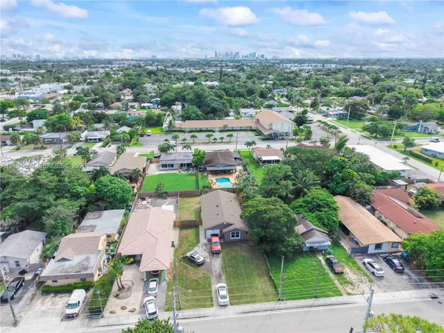 Aerial perspective featuring expansive residential lots with mature trees, established landscaping, and paved driveways