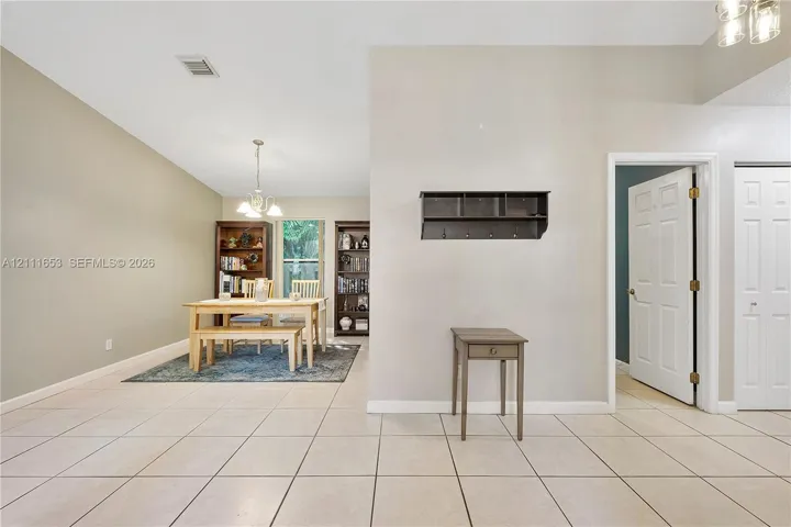 Ceramic tile flooring, vaulted ceilings, and a built-in wall-mounted coat rack