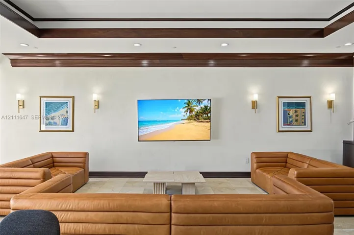 Tray ceiling featuring dark wood-finish trim, recessed lighting, and four wall-mounted sconces