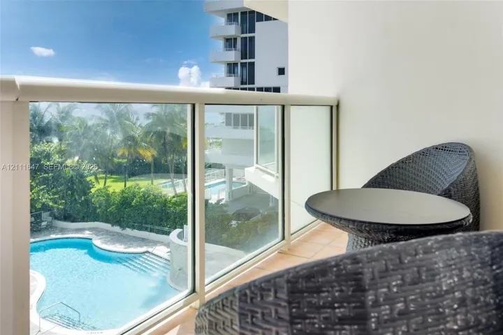 Balcony featuring glass panel railing and tile flooring