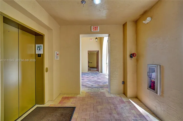 Elevator access, brick paver flooring, and recessed ceiling lighting