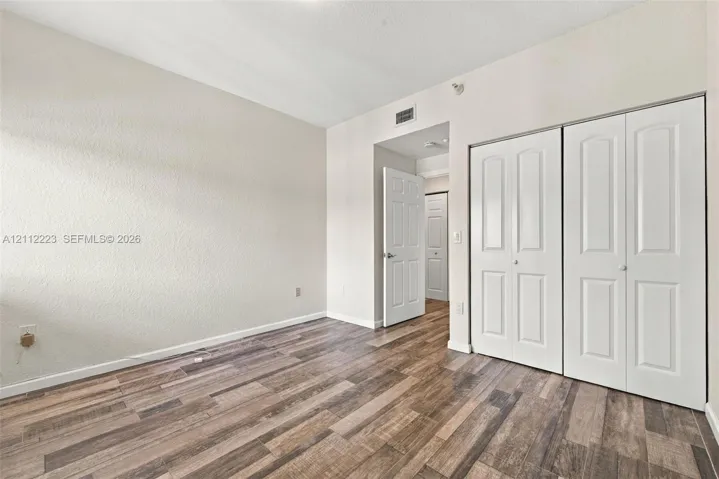 Wood-finish flooring, dual-panel closet doors, and interior solid-core doors