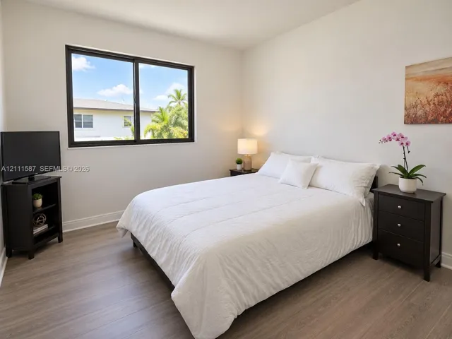 Wood-finish flooring and black-framed horizontal sliding window