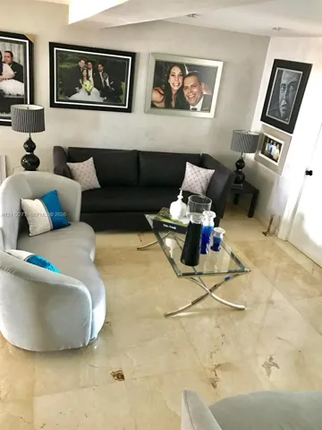 Large-format stone flooring throughout the room and recessed ceiling lighting
