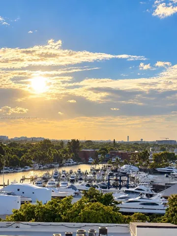 Marina frontage featuring multiple boat slips and a sprawling harbor landscape