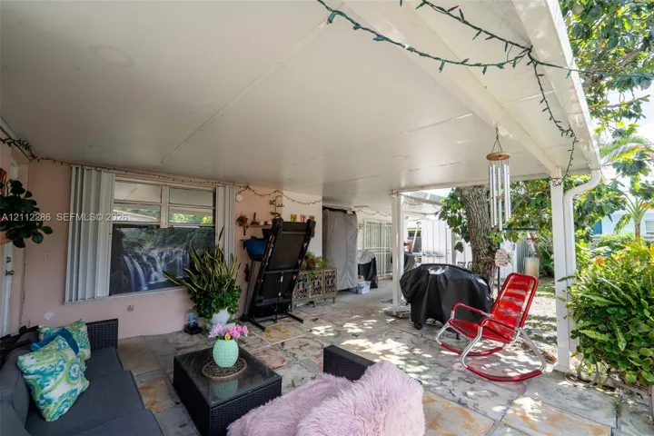 Covered patio featuring a solid-surface ceiling, recessed lighting, and multi-tone stone flooring