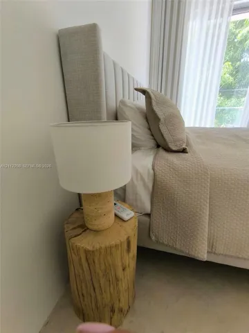Neutral-toned floor-to-ceiling window treatments and light-colored wall finish