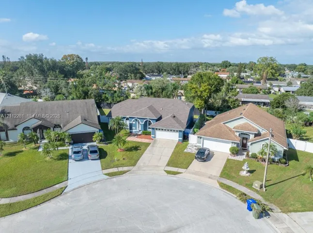 Single-story residence featuring a multi-gable roofline, a concrete driveway, a two-car garage, and established landscaping situated in a cul-de-sac