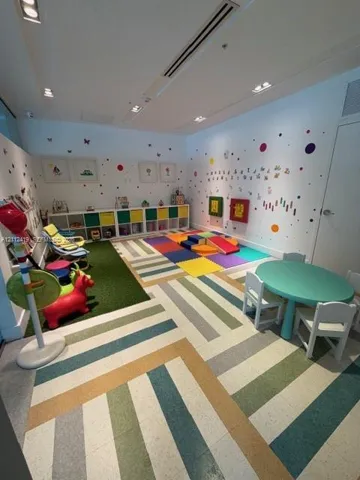 Multi-purpose room featuring recessed ceiling lighting, integrated cubby storage, and patterned vinyl flooring
