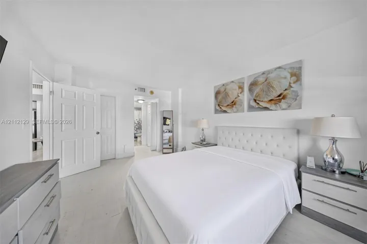 Neutral color palette featuring white walls, multi-panel interior doors, and light-toned flooring