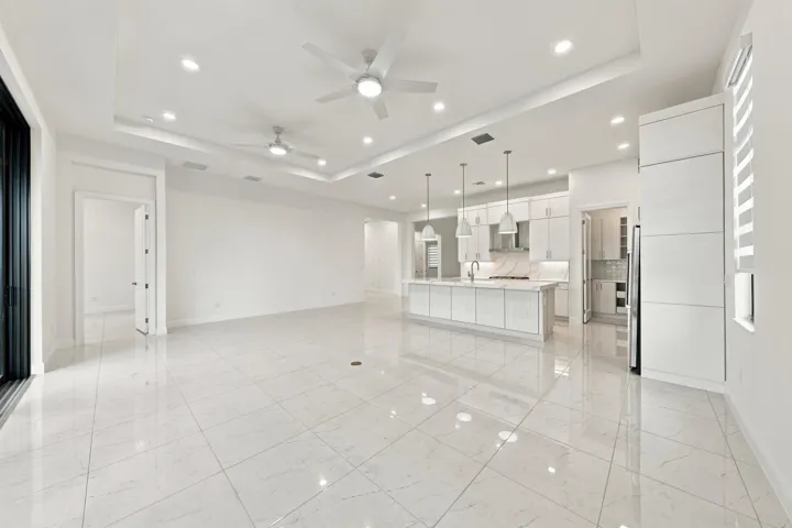 Dining area, great room and kitchen with raised tv outlet and level 5 upgraded tile floors throughout the home