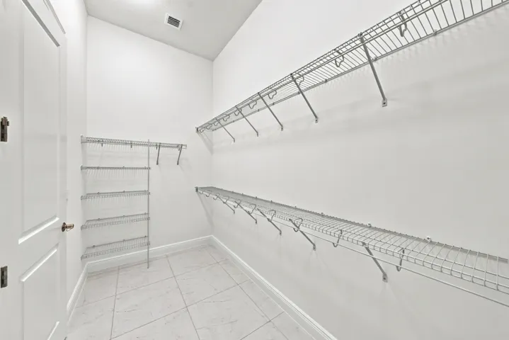 Primary bedroom walk-in closet