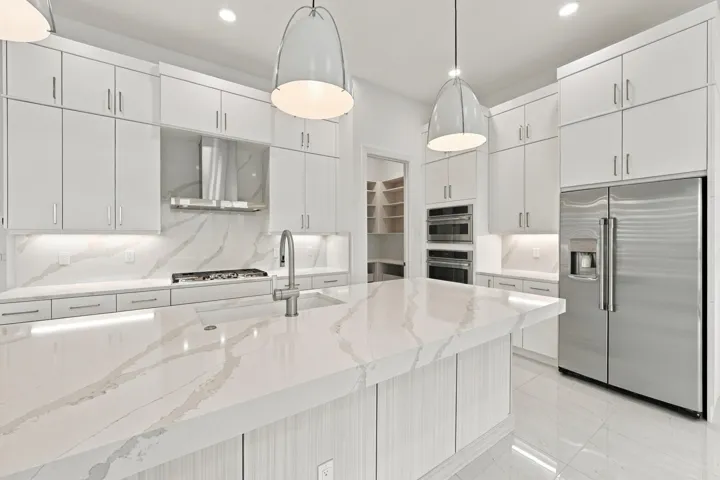 Upgraded soft close doors and cabinets with crown molding, under cabinet lighting and granite sink